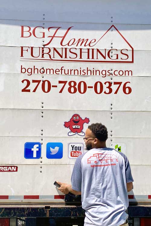 BG Home Movers long distance movers, mover lifting back gate of moving truck.